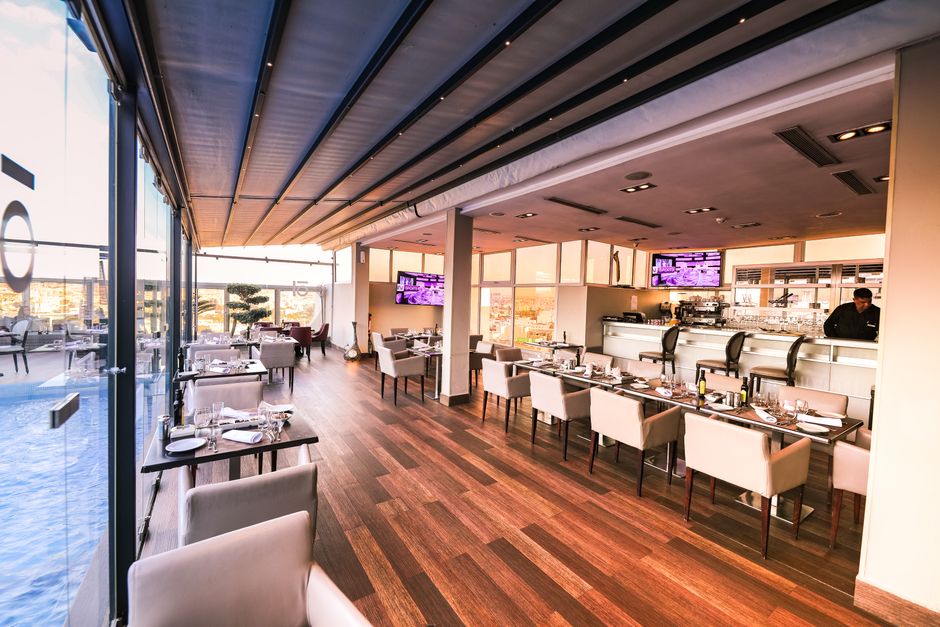 Modern restaurant dining room with contemporary design, open floor plan, and warm accent lighting